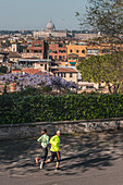 Joggers near Piazza del Popolo, with St. Peter's Basilica in the background, Rome, Lazio, Italy, Europe
