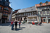 Gothic house, historic town hall on the left, tourists, Wernigerode, Saxony-Anhalt, Germany