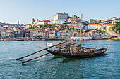 Barcos Rabelos, port wine boats on the Duero River in front of the historic old town of Porto, Portugal