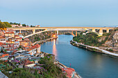 Three bridges over the Douro river in Porto, Portugal in the evening