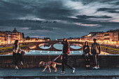Woman with dog, people enjoying evening mood, bridge over Arno, Florence, Tuscany, Italy, Europe