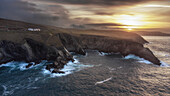 Sunrise at Mizen Head Visitor Center. View from the sea on cliffs. signal station. County Cork, Ireland.