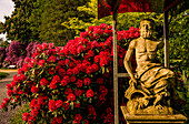 Statue of a river god in the rhododendron garden of Schloss Lembeck, Dorsten, North Rhine-Westphalia, Germany