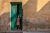 Girl in doorway, Varanasi, India