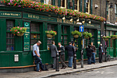 People standing outside a London pub, the Market Porter,London, England