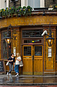 Two women drinking outside the Southwark Tavern London pub,London, England