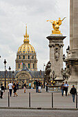People on Pont Alexandre III, Paris , France with Les Invalides in the backgroun