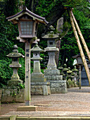 Stone and wooden lantern toro, Forest Shinto Shrine entrance, Kashima Jingu, Jap