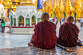 Buddhist monks looking at Shwedagon Pagoda, Myanmar, Asia