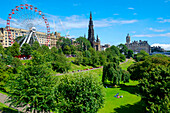 Ferris wheel and Scott monument in park in Edinburgh, UK