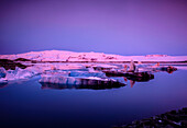 Ice floes in Iceland in pink light at dusk