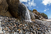 Water falling on rocky beach at Hug Point state park, USA