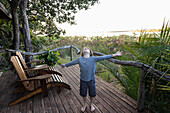 Young boy on a viewing terrace in a permanent camp in the Okavango Delta, Botswana.