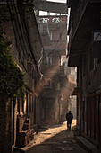 Person in the narrow streets at Durbar Square, Patan, Laitpur, Nepal, Himalaya, Asia