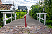 Wooden houses at Schellingwouderdijk, wooden bridge, Amsterdam, North Holland, Netherlands