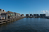 Characteristic wooden houses, sailing boats, harbour, Marken peninsula, near Amsterdam, North Holland, Netherlands