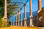 Walkway with Column and Arch with Mountain View in a Sunny Day in Lugano, Ticino, Switzerland.