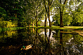 Pond and guest house in the spa gardens of Bad Oeynhausen in the evening light, North Rhine-Westphalia, Germany