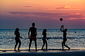 Young people volley ball in the sunset, beach of St. Peter Ording, district of Ording, St. Peter Ording, North Friesland, North Sea coast, Schleswig Holstein, Germany, Europe