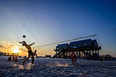 Volleyball players in the evening light on the beach, Sankt Peter Ording, North Friesland, North Sea coast, Schleswig Holstein, Germany, Europe