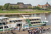 Tourists on the banks of the Elbe on a paddle steamer. Opposite the Saxon State Ministry of Finance on the Elbe.
