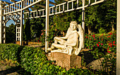 Rosarium in the spa park of Bad Wildbad with round pergola and Icarus with wings, Baden-Württemberg, Germany