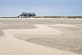 Sandy beach of St. Peter-Ording with stilt houses in the background, St. Peter-Ording, Wadden Sea National Park, Schleswig-Holstein, Germany