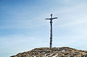 The picturesque summit cross of the Hinteren Hörnles in spring, Bad Kohlgrub, Bavaria, Germany