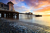 Sunrise at Penarth Pier in South Wales,captured from the waters edge in mid February using a long shutter speed to blur the movement in a receding wave.