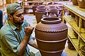Sultanate of Oman,Ad-Dakhiliyah Region,Bahla,potter at the factory.
