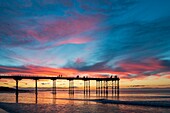 Saltburn by the sea,North Yorkshire,England. United Kingdom. The sun sets behind Saltburn`s Victorian pier; the last remaining pier on the Yorkshire coast.