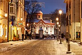 Winter evening in Vilnius old town,Lithuania. Orthodox church in the distance.
