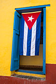 Cuban flag in doorway, Trinidad, Sancti Spiritus, Cuba, West Indies, Central America