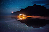 Polihale State Park under a starry sky with sparks being reflected in a tidal pool, Hawaii, United States of America, Pacific