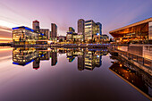 Mirror view at sunset of Salford Quays and Media City, Salford, Manchester, England, United Kingdom, Europe