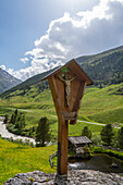 Jesus on the cross in front of an alpine backdrop, mountaineering village of Vent, Oetztal, Tyrol, Austria