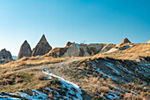Turkey, Cappadocia, Goreme, Rock formations with snow patches