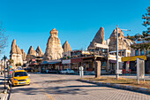 Turkey, Cappadocia, Goreme, Buildings with fairy chimneys in background
