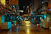 View of street and closed market stall at night in Hong Kong