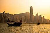 Traditional junk boat sailing across Victoria Harbour, Hong Kong