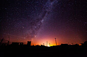 View of abandoned village against milky way and star trail in sky, Villa Epecuen