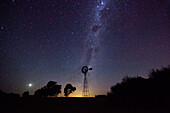 View of aermotor windmill against milky way in sky