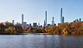 USA, New York, New York City, Midtown Manhattan skyscrapers seen across pond in Central Park