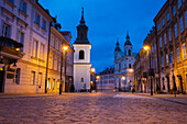 Poland, Masovia, Warsaw, Cobblestone street in old town at night