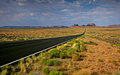Arizona, Monument Valley Tribal Park, Empty road in desert leading to Monument Valley