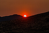 USA, Idaho, Bellevue, Sun setting behind hills