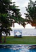 Cambodia, Canopy bed in hotel overlooking ocean