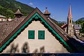 View of the gable of the historic building of the radon thermal vapor bath and the parish church in Bad Gastein, Salzburger Land, Austria