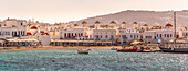 View of windmills overlooking town and harbour at golden hour, Mykonos Town, Mykonos, Cyclades Islands, Greek Islands, Aegean Sea, Greece, Europe