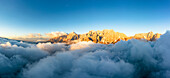 Aerial view of Popera group, Cima Undici and Croda Rossa di Sesto rock peaks emerging from clouds, Dolomites, South Tyrol, Italy, Europe